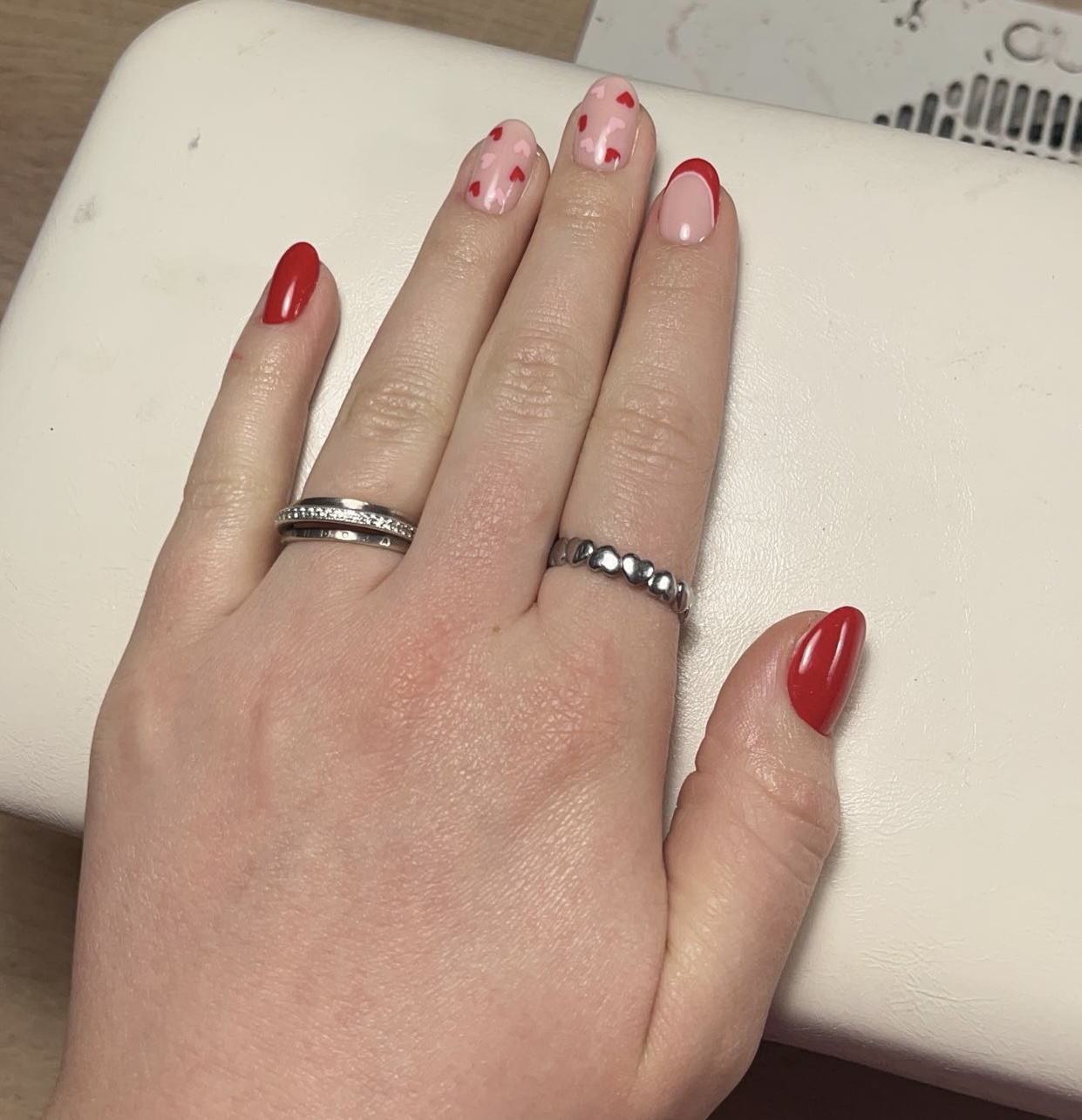 Rode en roze nagels met kleine hartjes